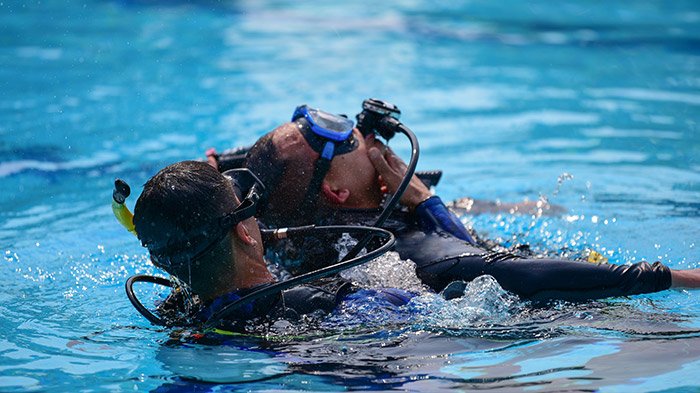 Rescue divers practising a tow at the surface